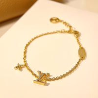 PULSERA DE ORO CON MOTIVO DE ESTRELLA Y LOGO [LUXE]