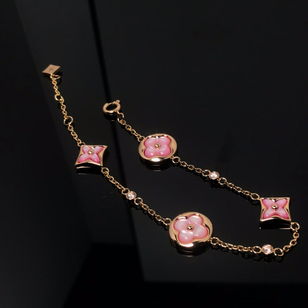 [LUXE] PULSERA DE ORO ROSA CON 4 MOTIVOS DE ESTRELLAS Y SOLES 