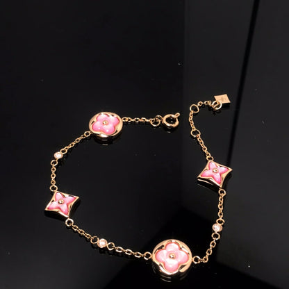 [LUXE] PULSERA DE ORO ROSA CON 4 MOTIVOS DE ESTRELLAS Y SOLES 