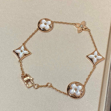 [LUXE] PULSERA DE ORO ROSA CON 5 MOTIVOS DE ESTRELLAS Y SOLES