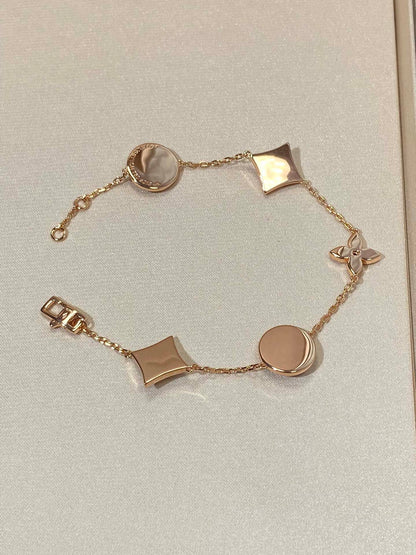 [LUXE] PULSERA DE ORO ROSA CON 5 MOTIVOS DE ESTRELLAS Y SOLES